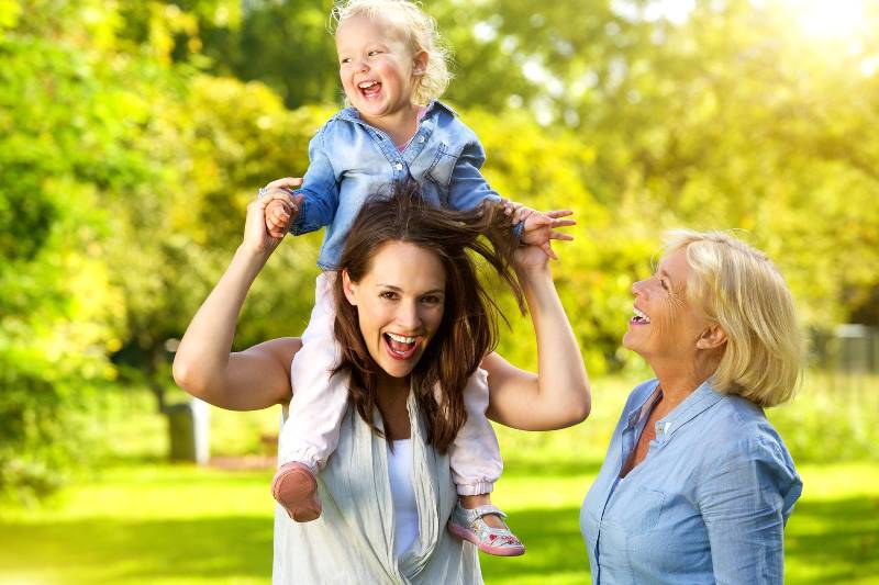 grandmother with mother with child on shoulders laughing variocose vein doctor st paul